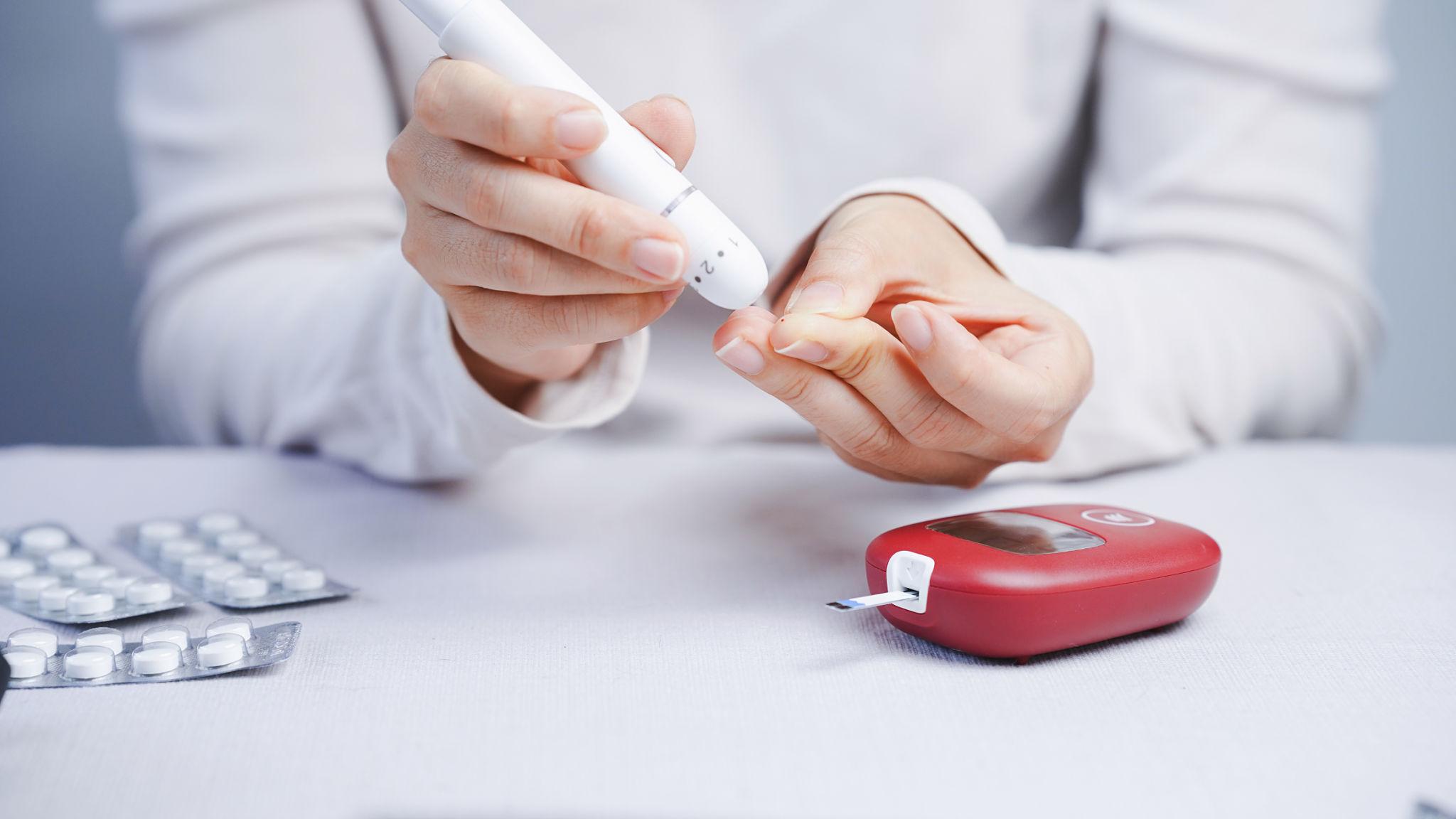 Blood sugar testing with glucose meter showing elevated reading